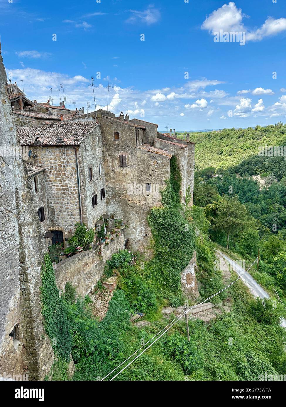 The photograph depicts a medieval stone city landscape, showcasing architectural details in the summer. - Smartphone Captured Stock Image