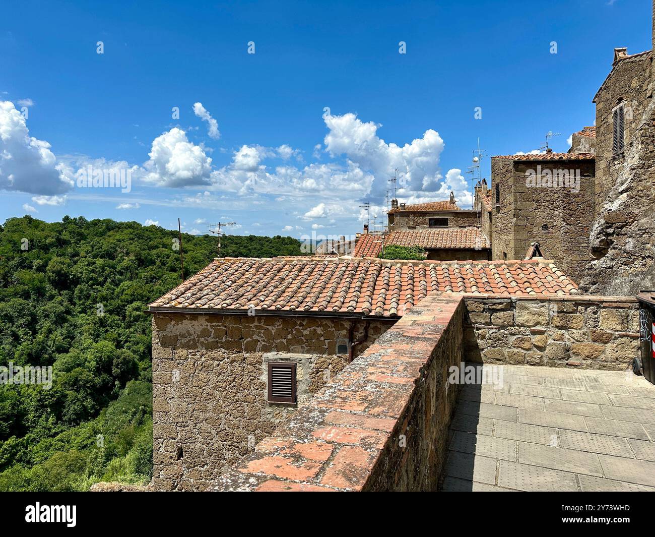 The photograph depicts a medieval stone city landscape, showcasing architectural details in the summer. - Smartphone Captured Stock Image