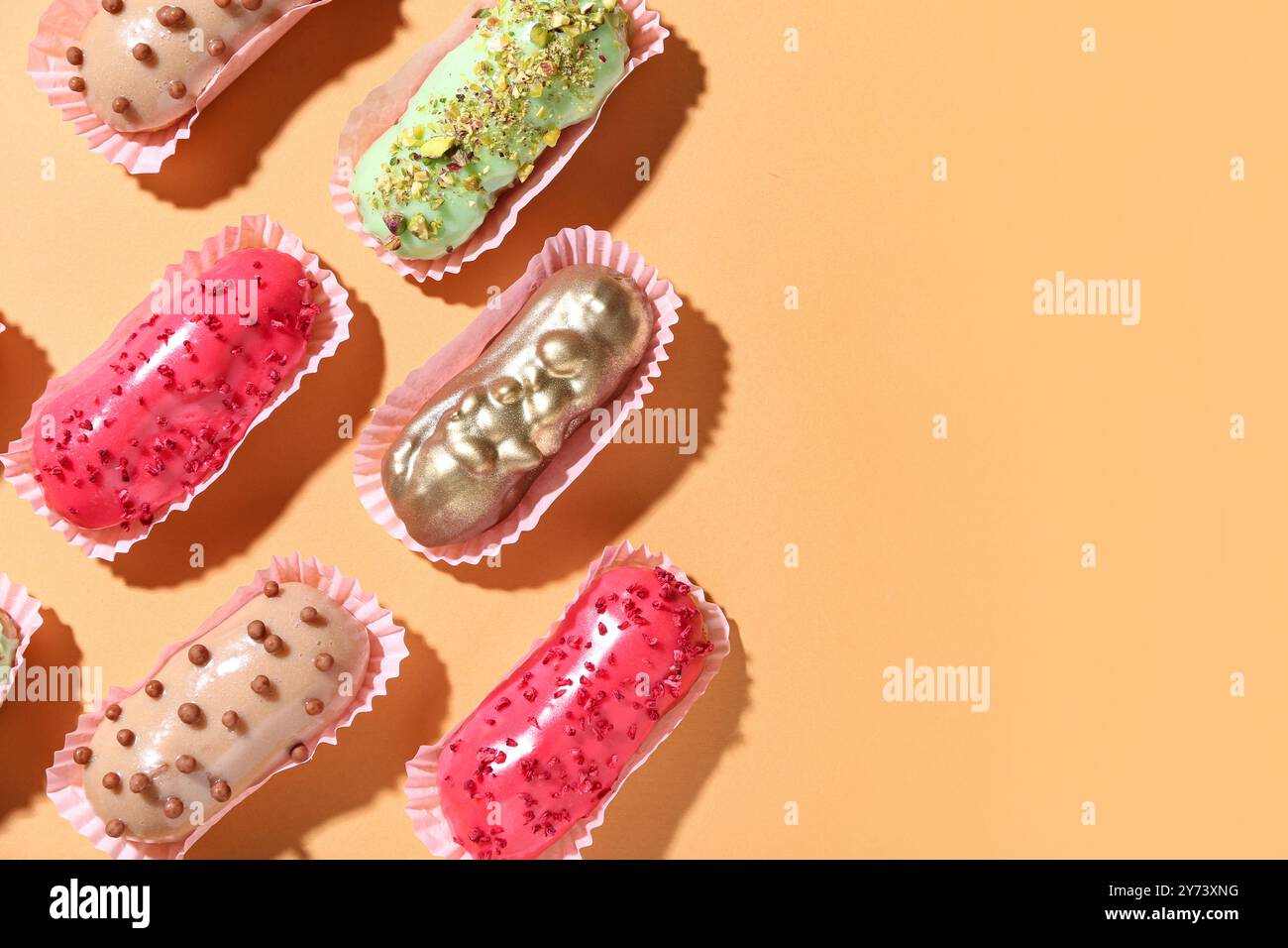 Composition with different glazed eclairs on color background Stock Photo