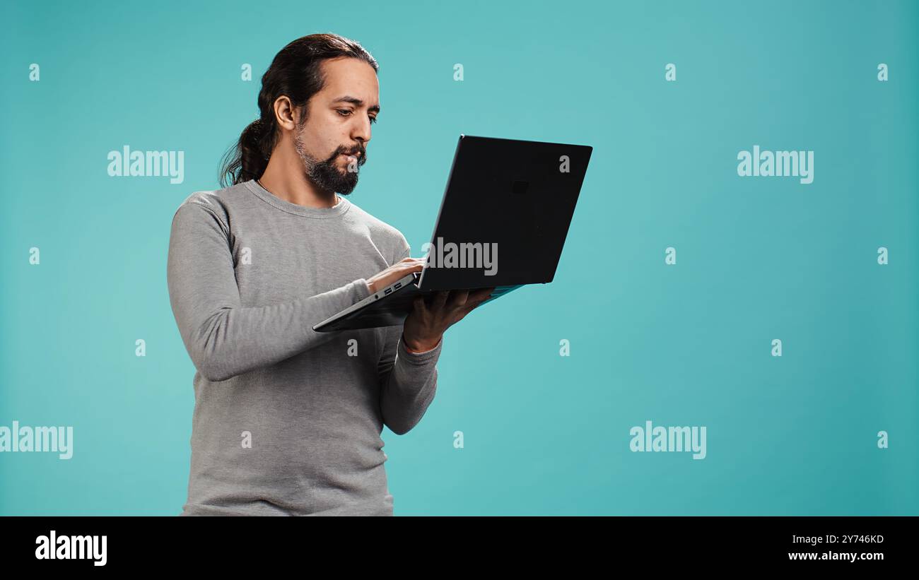 Man composing email typing on laptop keyboard excited to log off
