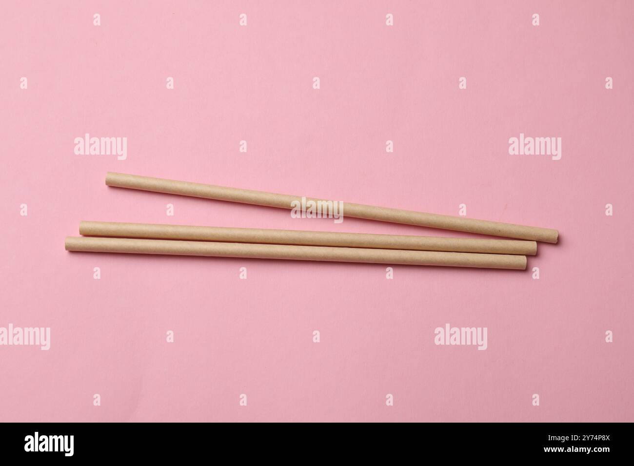 Bamboo drinking straws on pink background, top view Stock Photo