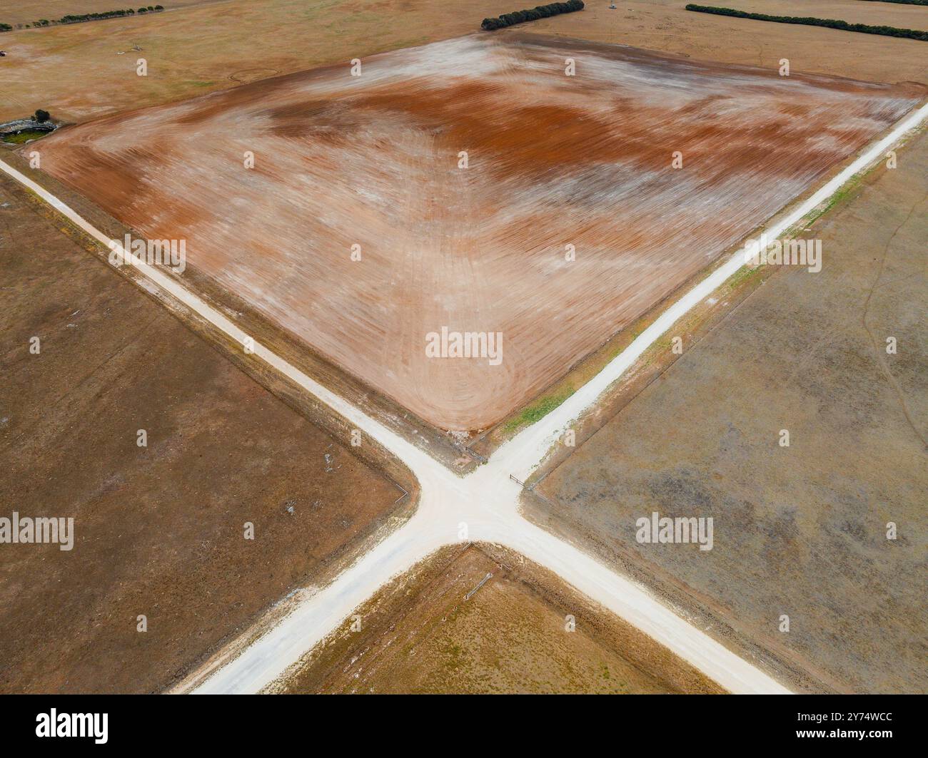 Aerial view of a rural crossroad of white dirt tracks with barren paddocks alongsdie at Mount Schank on the Limestone Coast in South Australia Stock Photo