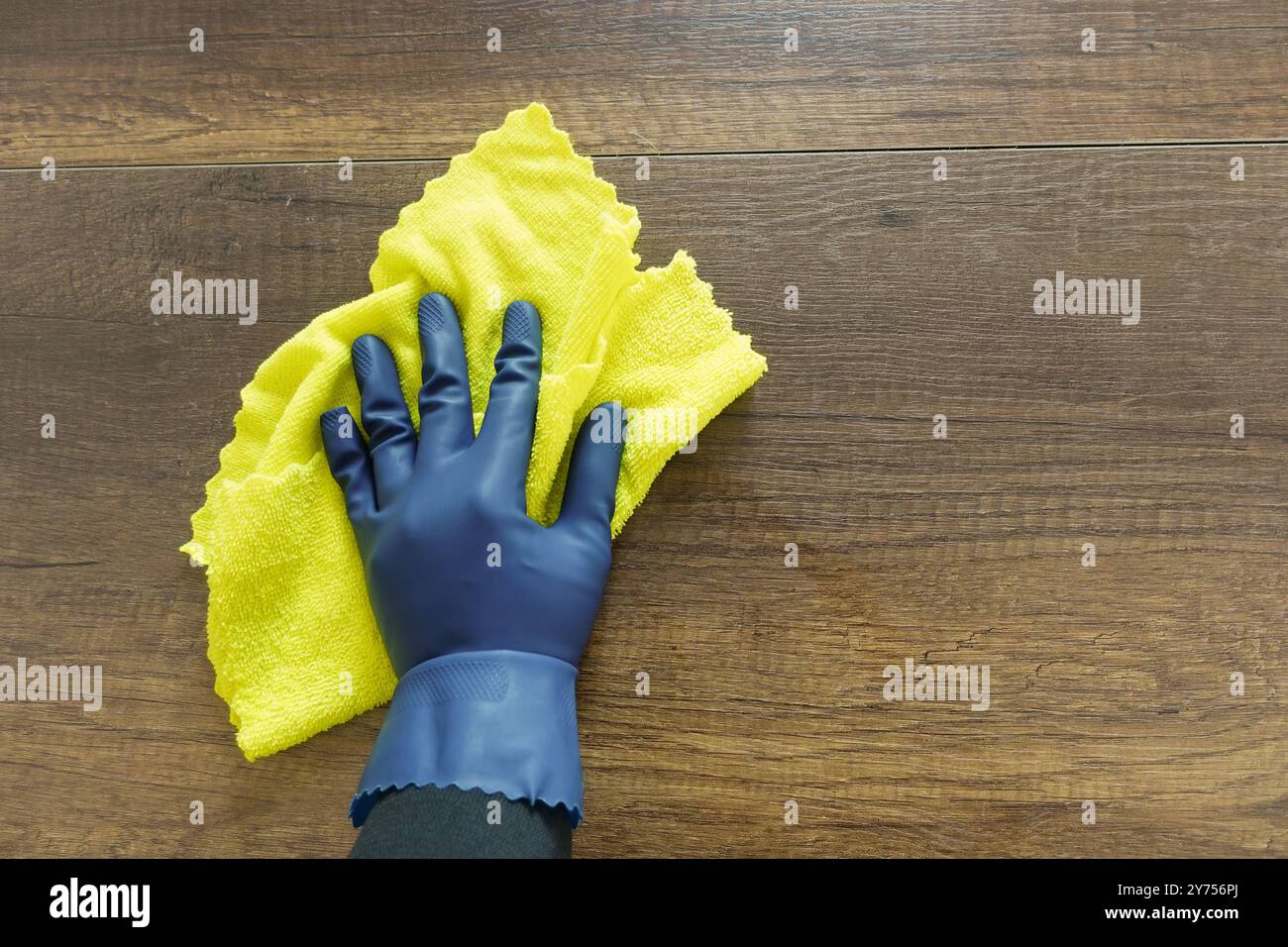 hand in blue rubber gloves cleaning table with cloth Stock Photo - Alamy