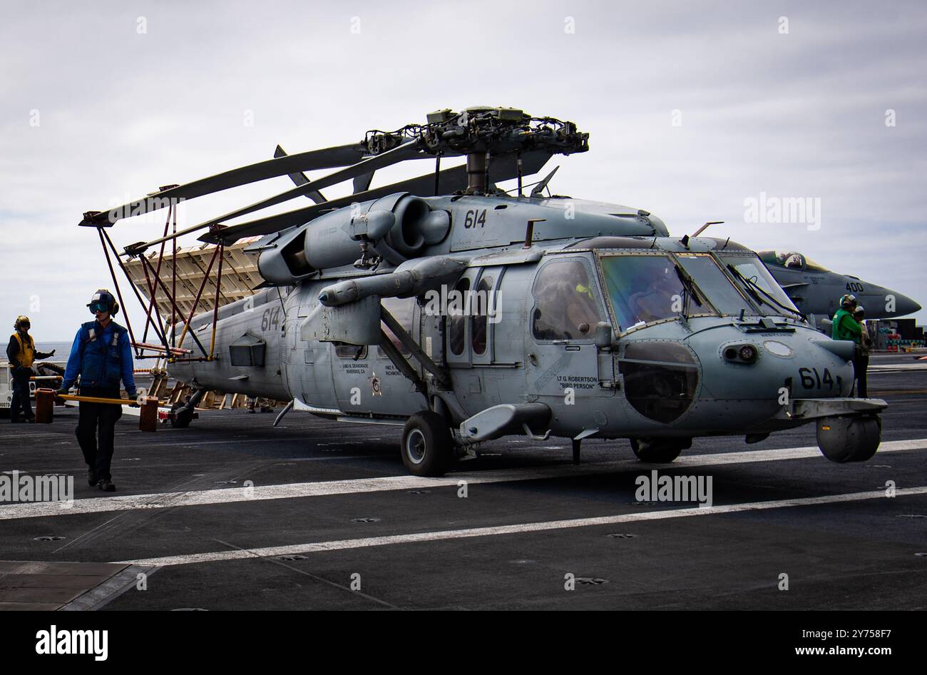 Sailors prepare an MH-60S Sea Hawk helicopter from the “Screamin ...