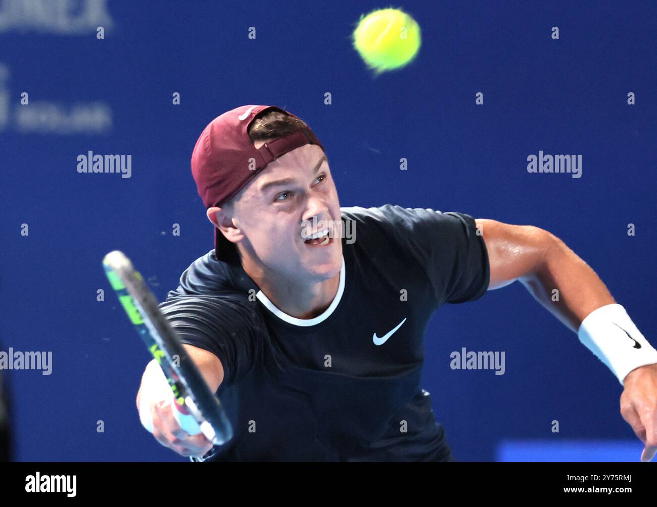 Tokyo, Japan. 28th Sep, 2024. Holger Rune of Denmark retuens the ball ...