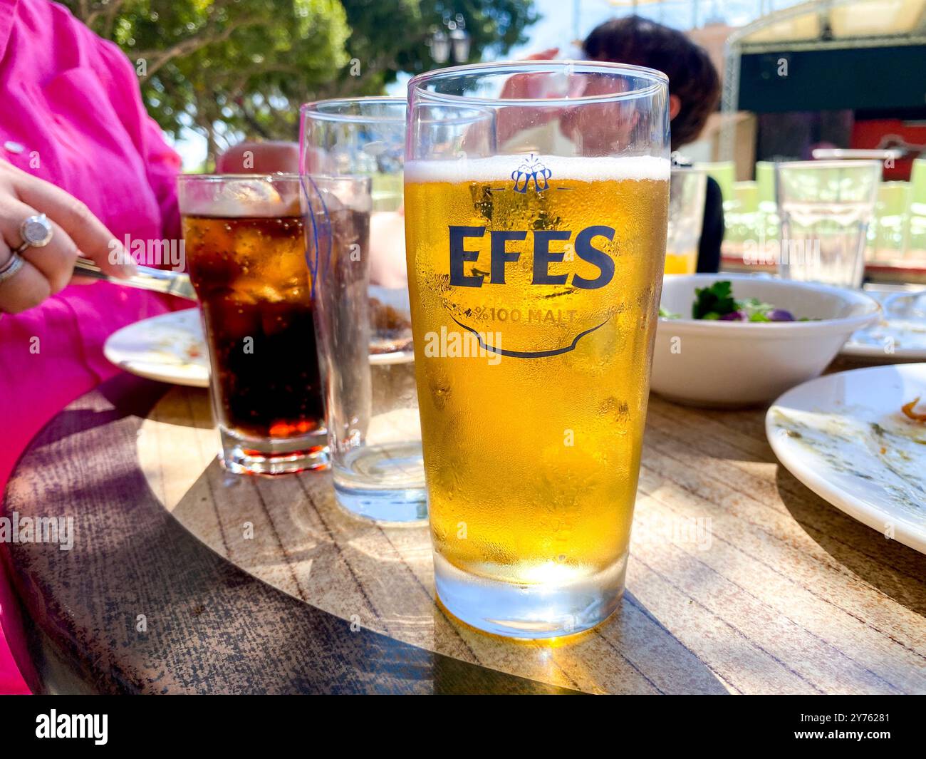 An Efes beer on a table at lunch. - Smartphone Captured Stock Image
