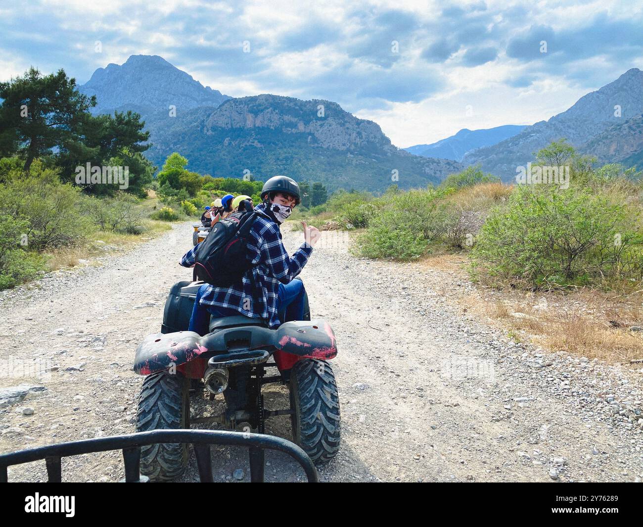 Riding quad bikes on a tour over dusty trails in Antalya, Turkey - Smartphone Captured Stock Image