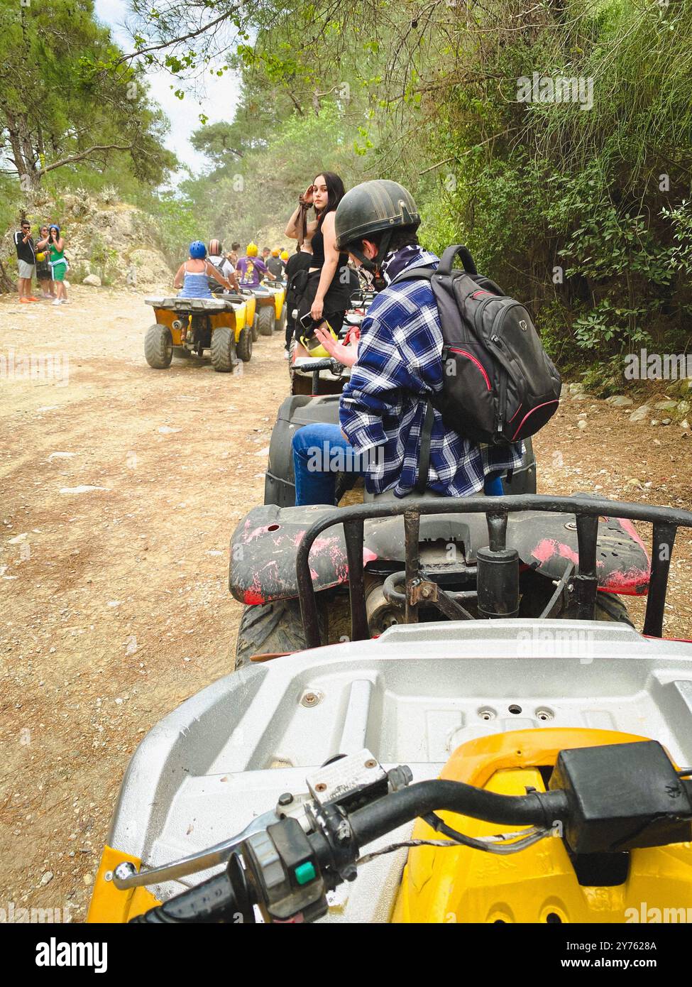Riding quad bikes on a tour over dusty trails in Antalya, Turkey - Smartphone Captured Stock Image