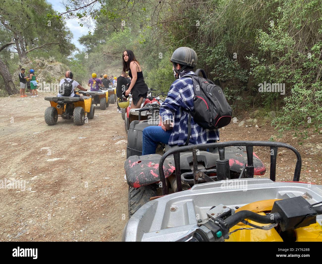 Riding quad bikes on a tour over dusty trails in Antalya, Turkey - Smartphone Captured Stock Image