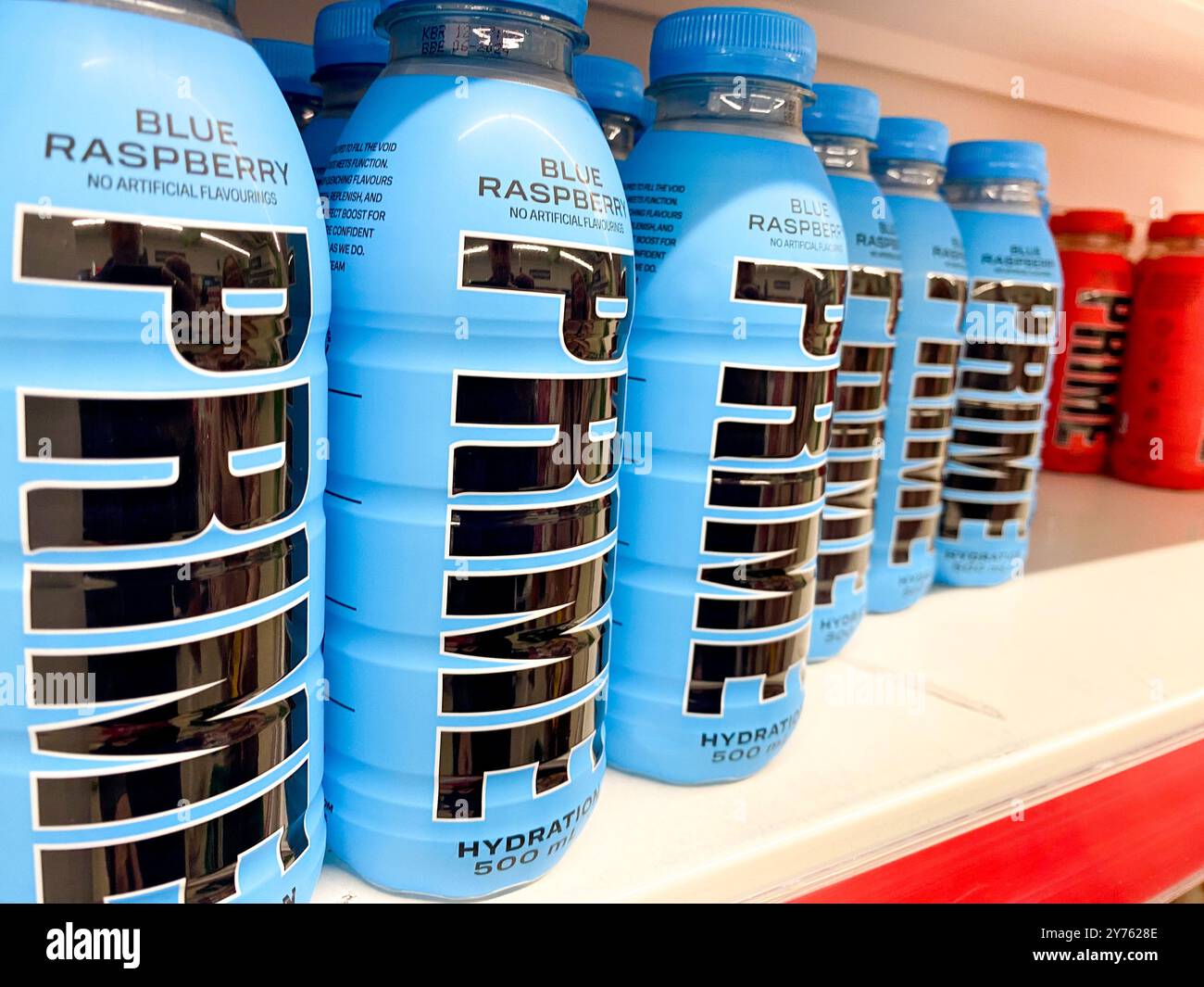 Bottles of Prime sports and energy drink on a supermarket shelf. - Smartphone Captured Stock Image