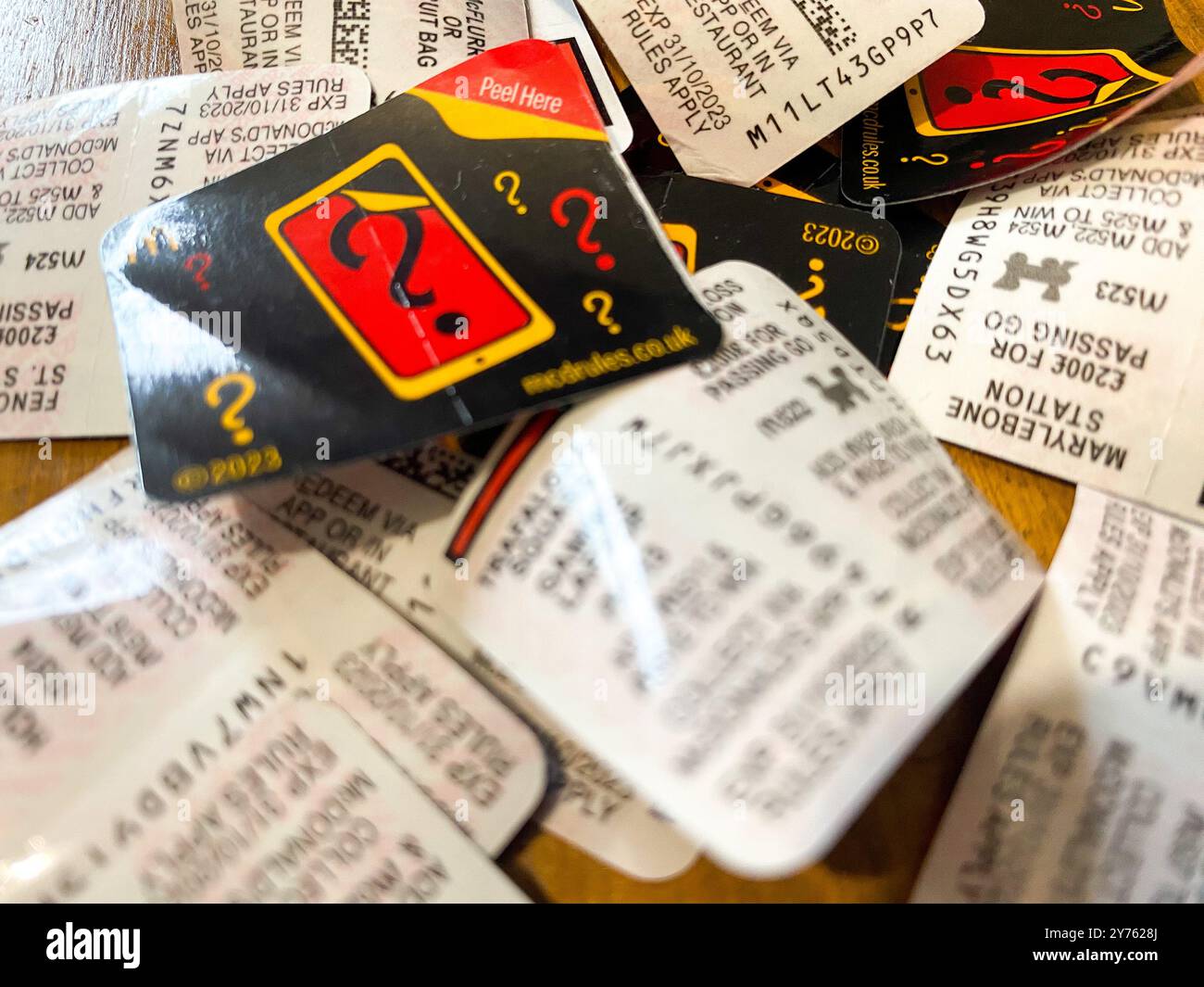 A pile of Monopoly game tickets taken off McDonald's food packaging. - Smartphone Captured Stock Image
