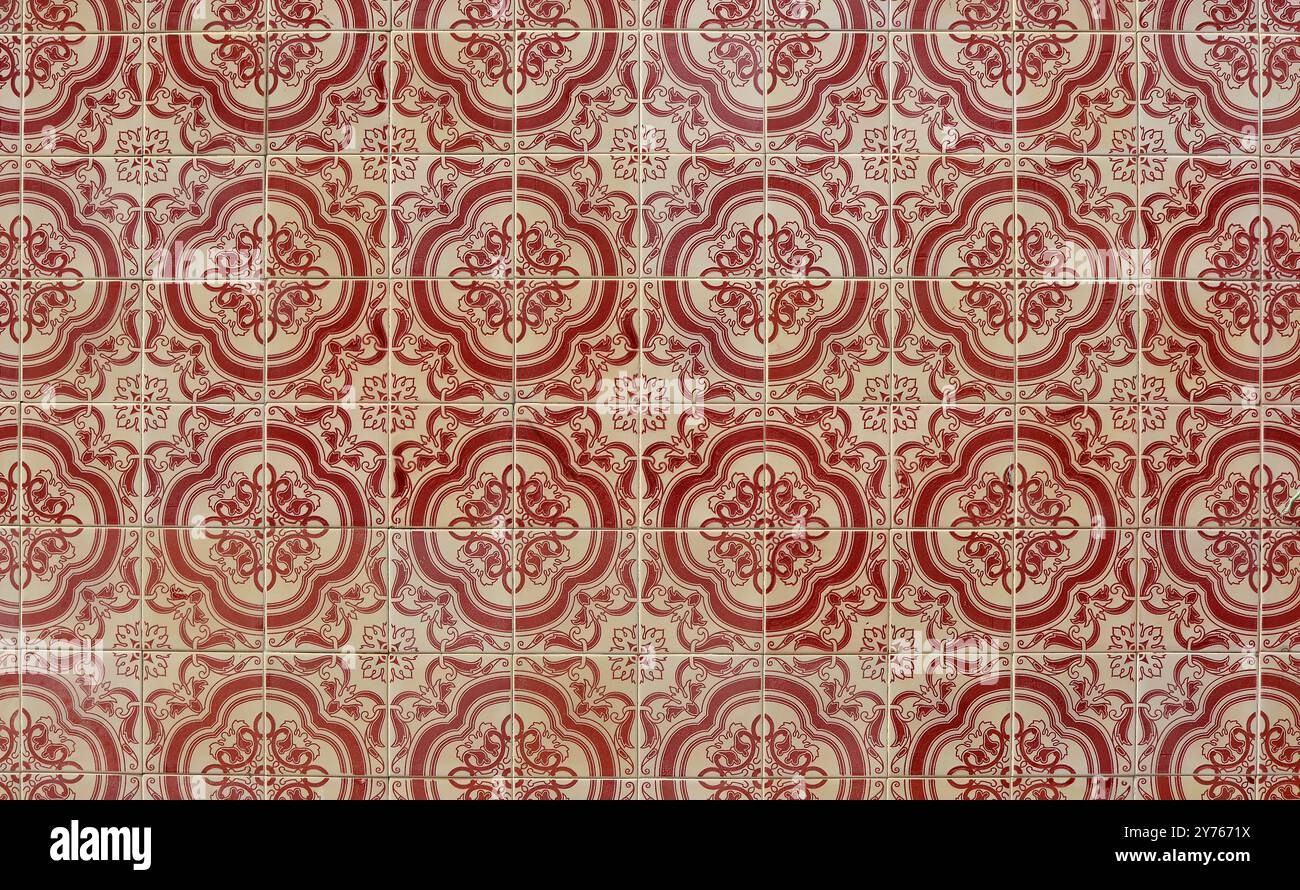 Azulejos, traditional Portuguese ceramic tiles on house wall, pattern background in red and beige, Tavira, Portugal Stock Photo