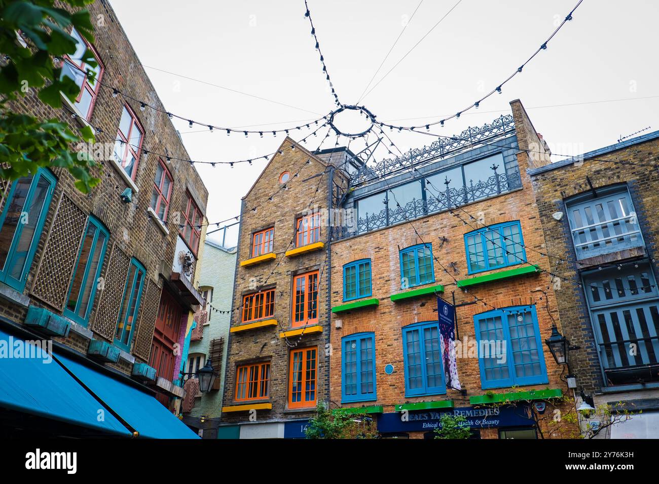 London, UK - July 25, 2024: Colurful Neals Yard courtyard. Neal's Yard is a small alley in London's Covent Garden. Popular tourist spot. Stock Photo