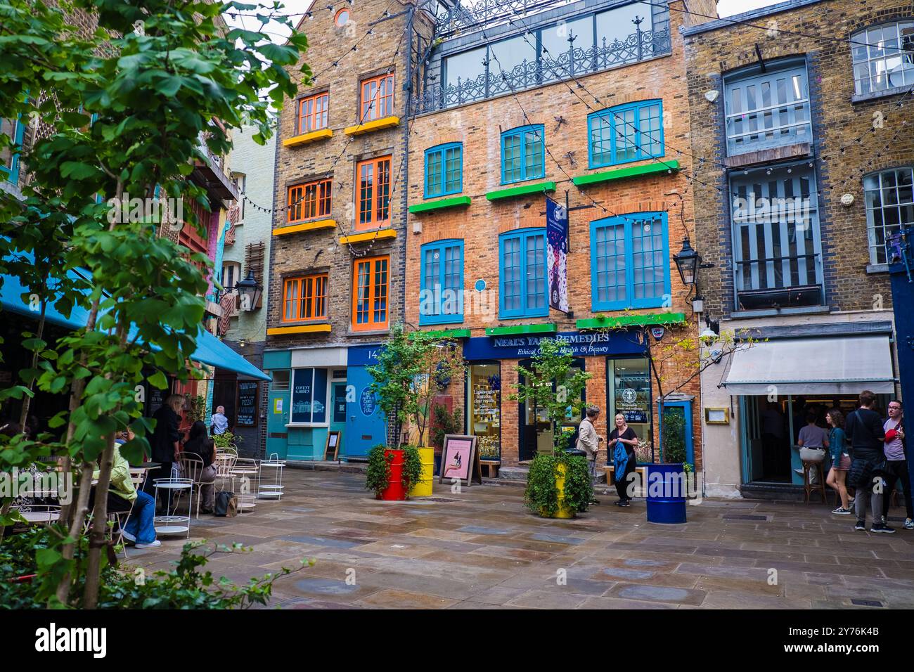 London, UK - July 25, 2024: Colurful Neals Yard courtyard. Neal's Yard is a small alley in London's Covent Garden. Popular tourist spot. Stock Photo