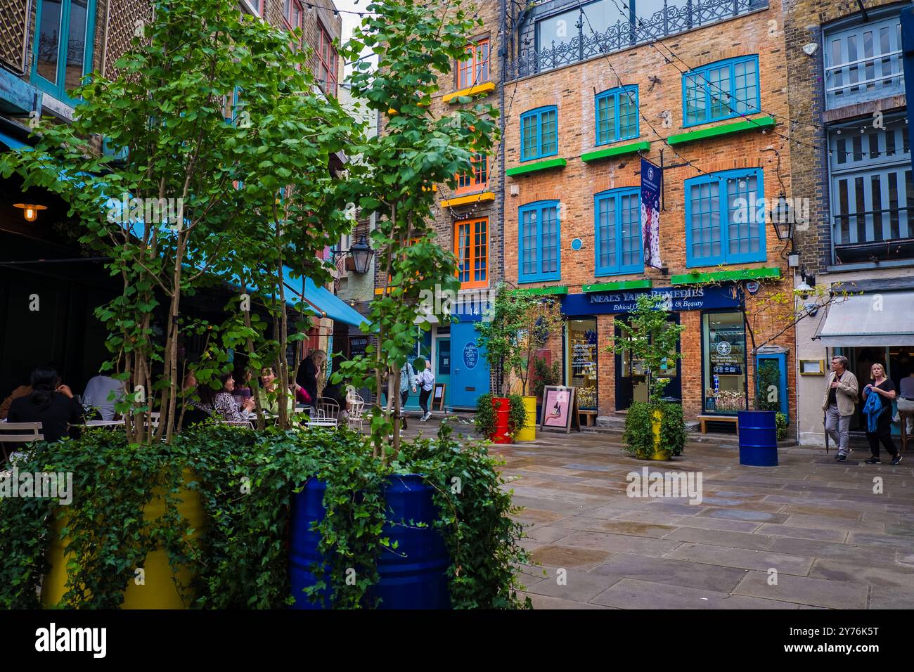 London, UK - July 25, 2024: Colurful Neals Yard courtyard. Neal's Yard is a small alley in London's Covent Garden. Popular tourist spot. Stock Photo