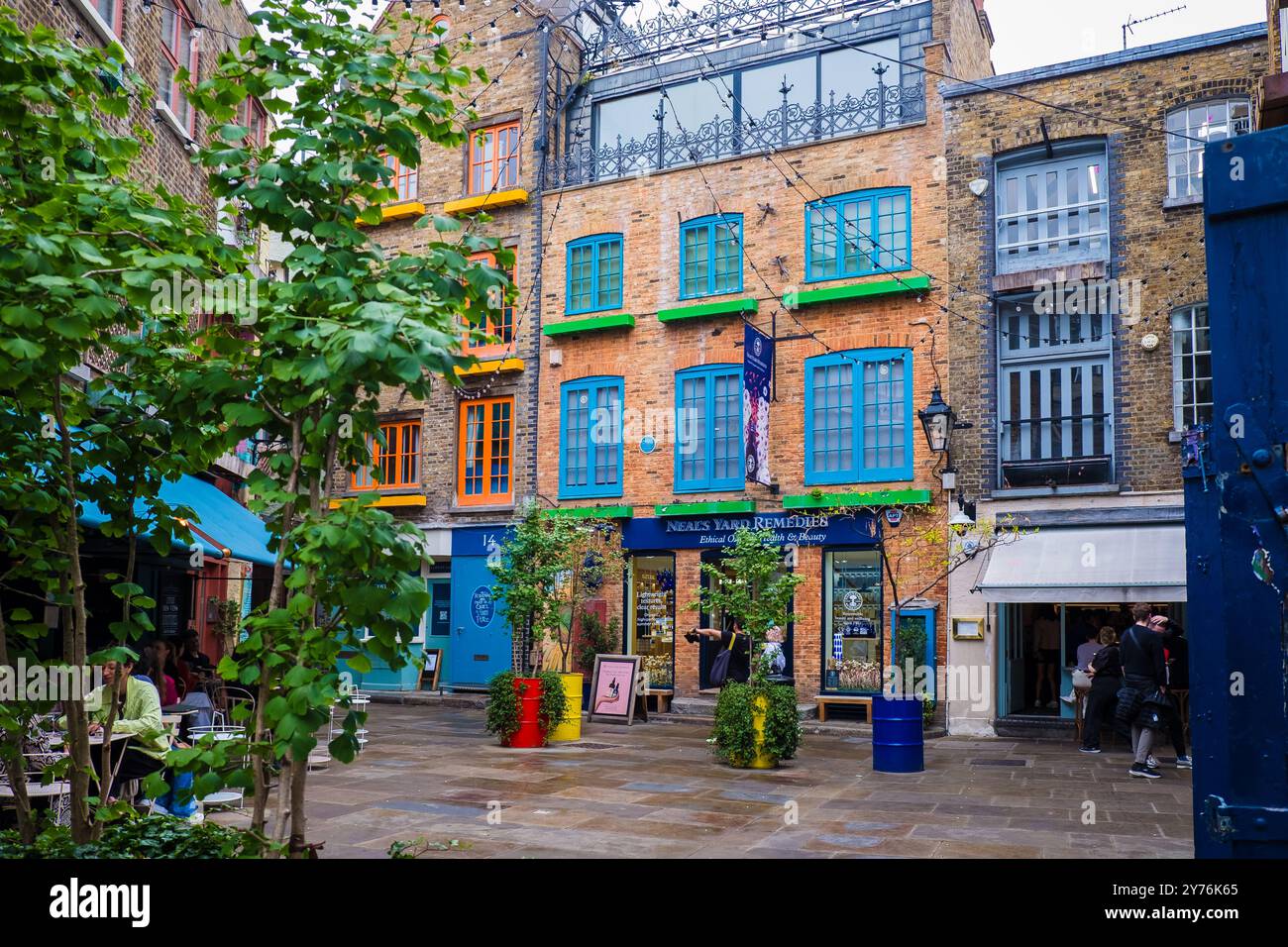 London, UK - July 25, 2024: Colurful Neals Yard courtyard. Neal's Yard is a small alley in London's Covent Garden. Popular tourist spot. Stock Photo