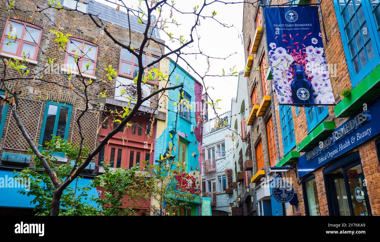 London, UK - July 25, 2024: Colurful Neals Yard courtyard. Neal's Yard is a small alley in London's Covent Garden. Popular tourist spot. Stock Photo