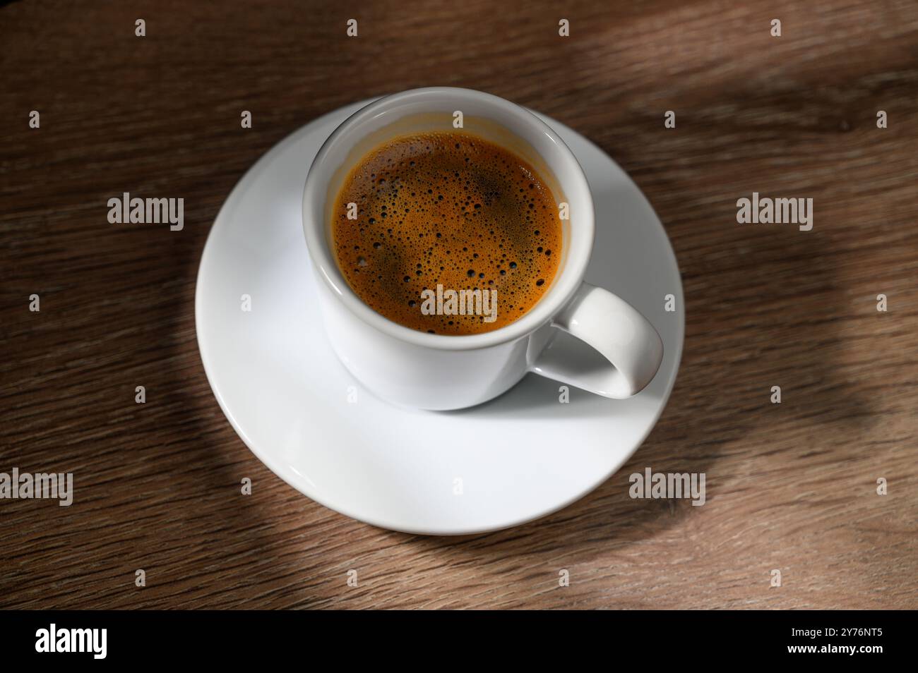 A cup of coffee on a wooden table. Stock Photo