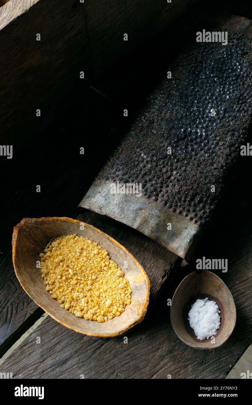 Amazonian traditional yellow seasoning in wooden cup Stock Photo