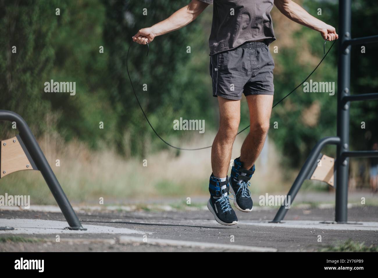Man jumping rope during outdoor workout in the park Stock Photo - Alamy