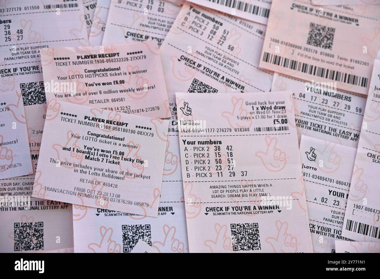 Lottery tickets and winning slips background UK National lottery and Euromillions. Stock Photo