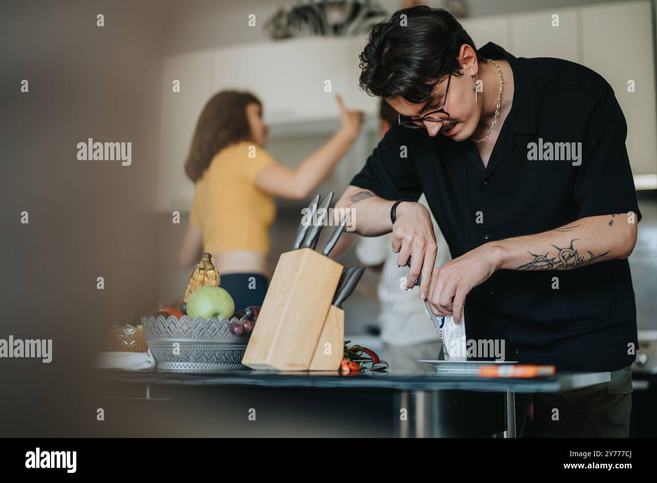 Man preparing food in a modern kitchen setting Stock Photo
