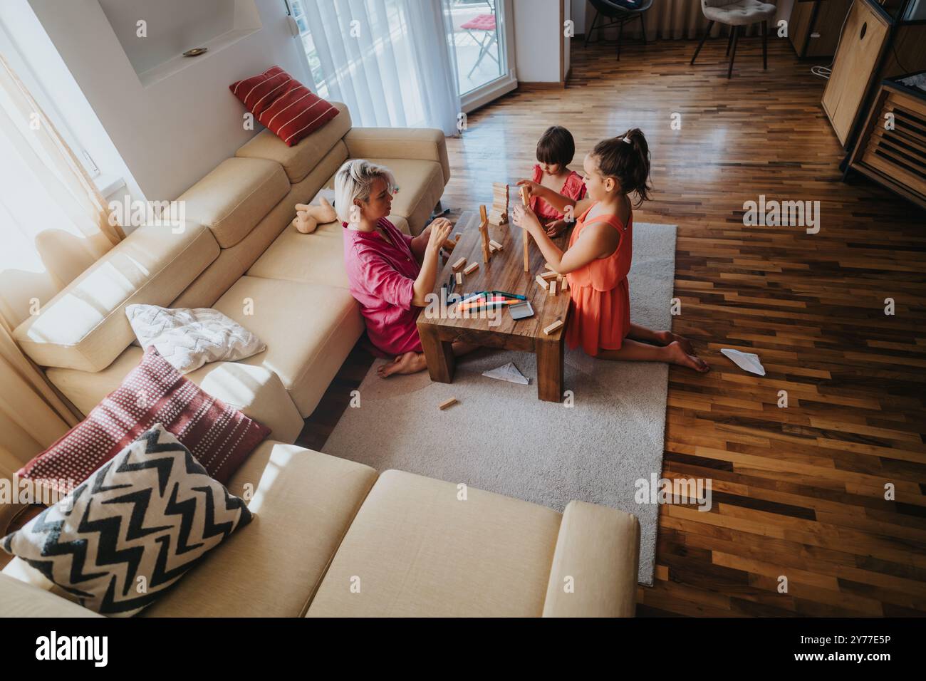 Family bonding through playful activities in a cozy living room Stock ...