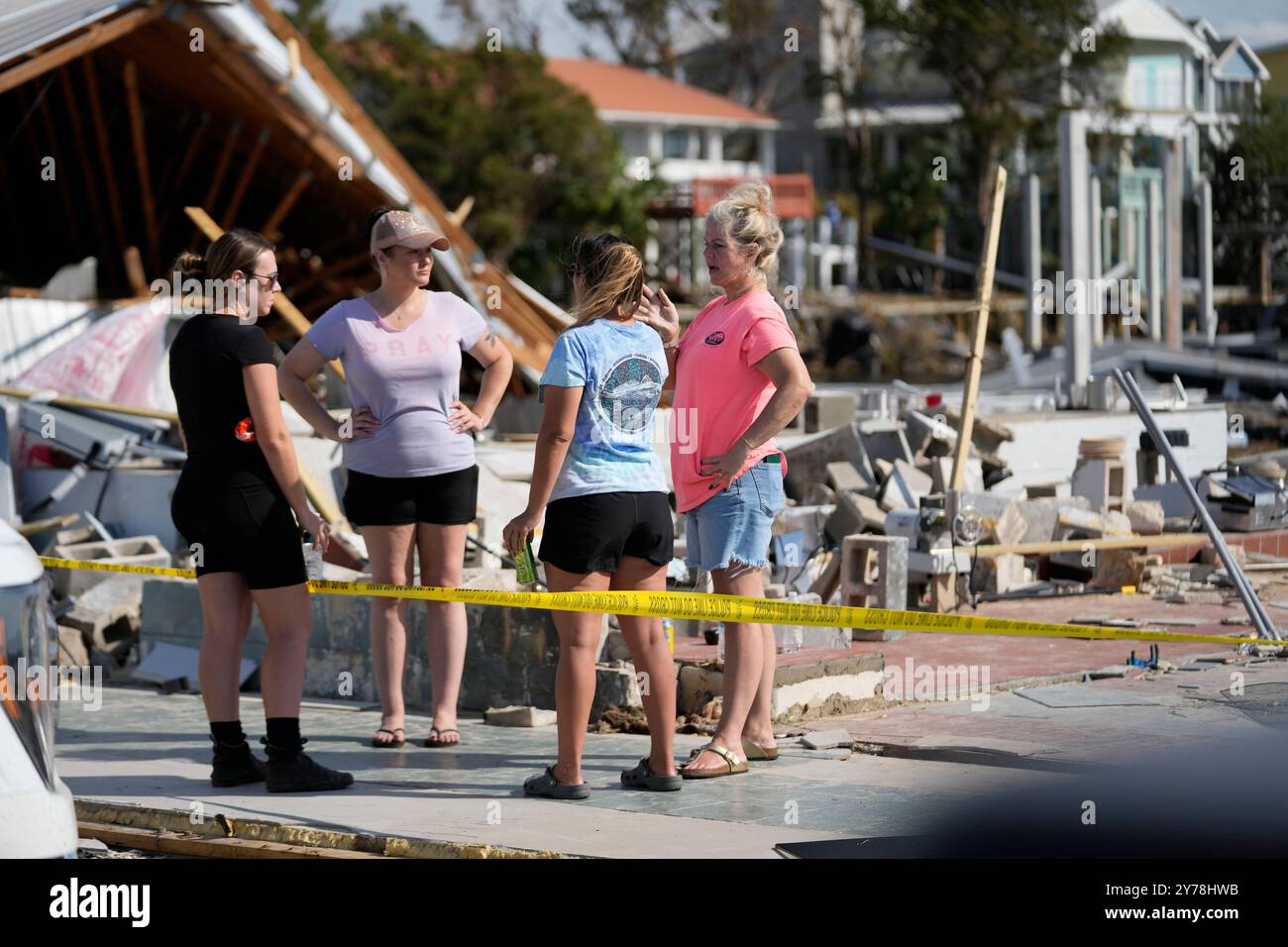 Owners and employees of Roy's Restaurant survey the business that was ...