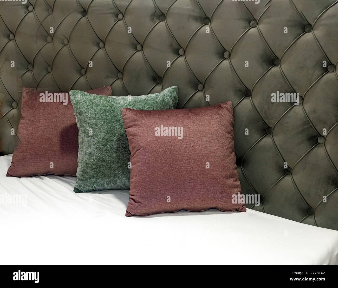 Colorful decorative pillows on empty bed inside modern interior Stock Photo