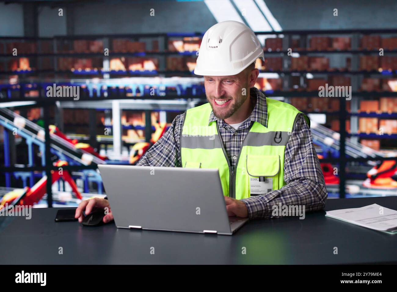 Man Staff In Parcel Delivery Center Using Computer Stock Photo