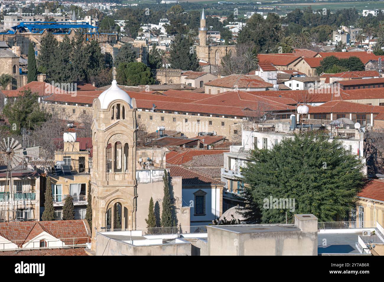 Panagia Faneromeni Church tower rising above traditional houses with red tile roofs in Nicosia, Cyprus Stock Photo