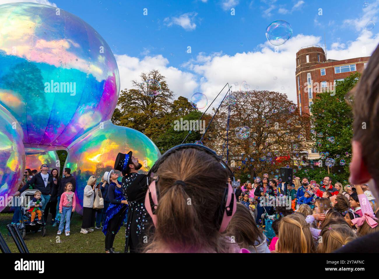 Bournemouth, Dorset, UK. 28th September 2024. Thousands flock to Bournemouth for the Arts by the Sea Festival with the theme of Taste, a fun time with quirky theatre, dance and music, providing spectacular shows and inspirational installations for free family entertainment. Audience young and old enjoy the Bubble Spectacular by Squidge & Pop. Credit: Carolyn Jenkins/Alamy Live News Stock Photo