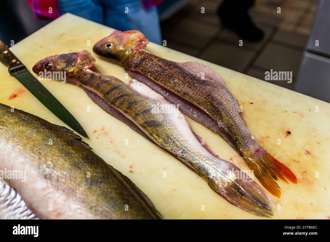 Chef René Bobzin prepares boneless fish with various potato dishes in ...