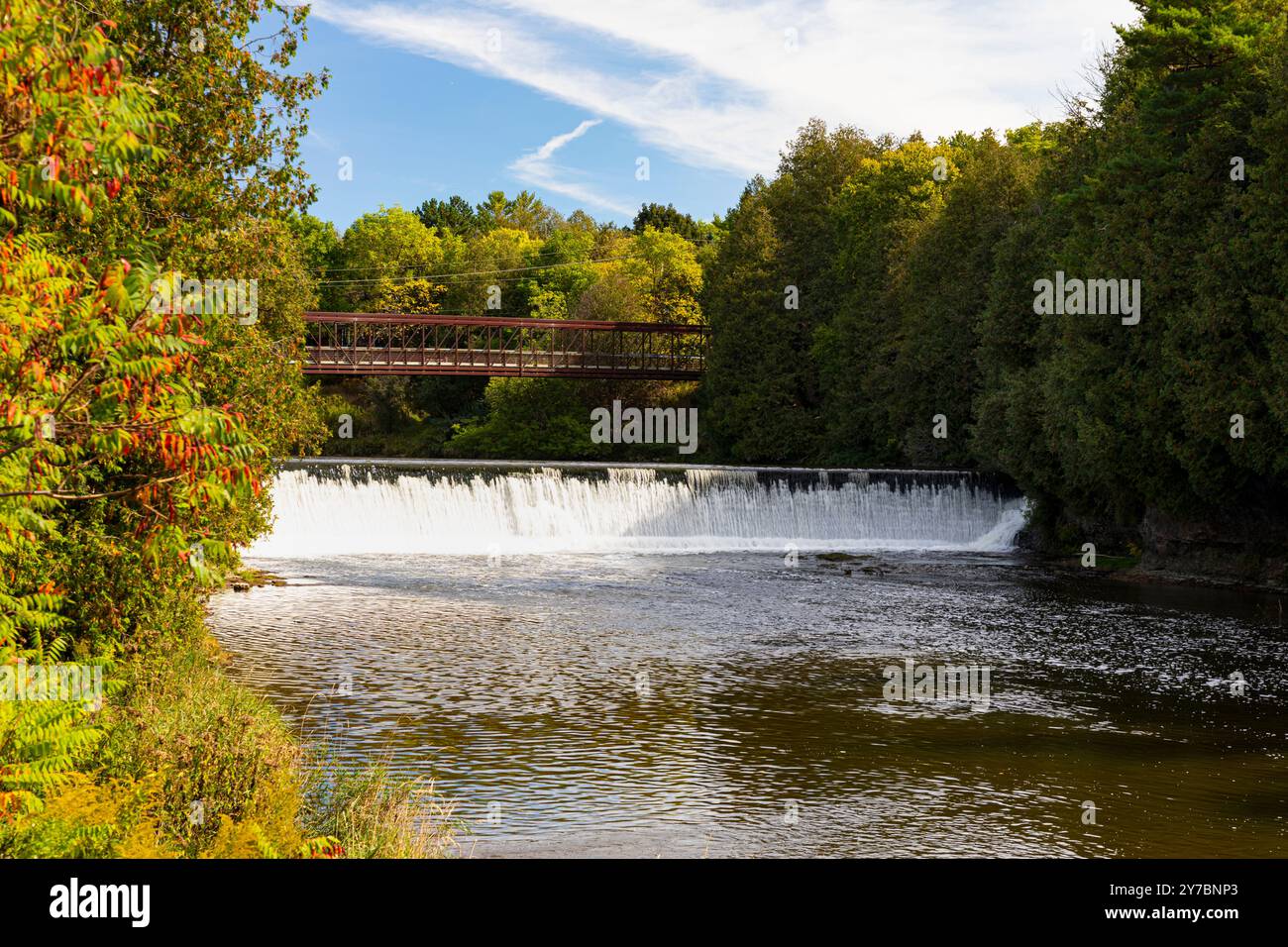 Elora Ontario Canada. Bissell Park Dam and foot bridge over Grand River. Stock Photo