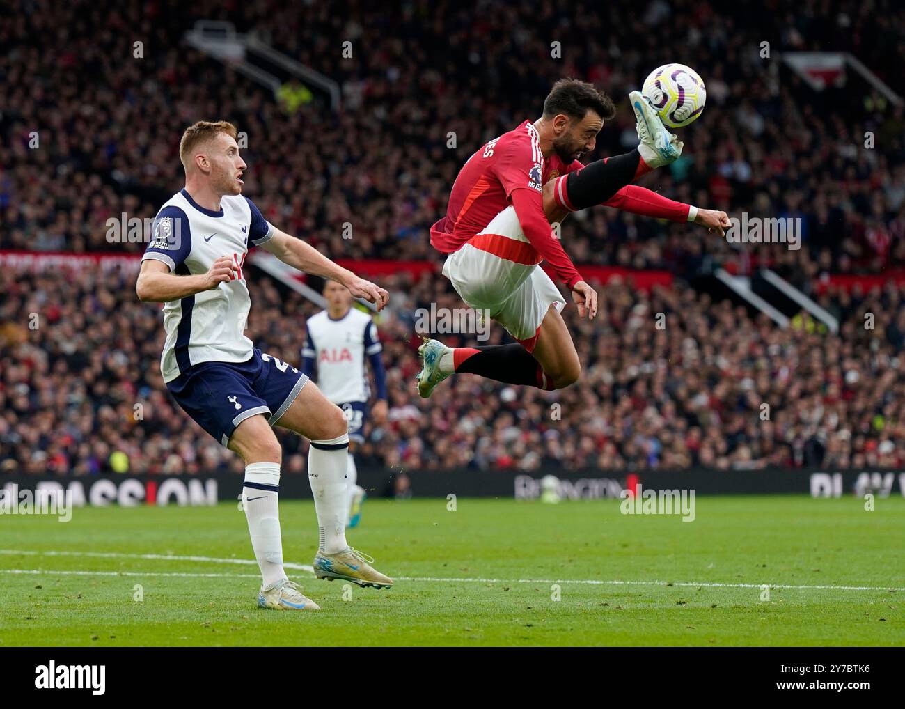 Manchester, UK. 29th Sep, 2024. Bruno Fernandes of Manchester United leaps up in front of Dejan Kulusevski of Tottenham during the Premier League match at Old Trafford, Manchester. Picture credit should read: Andrew Yates/Sportimage Credit: Sportimage Ltd/Alamy Live News Stock Photo