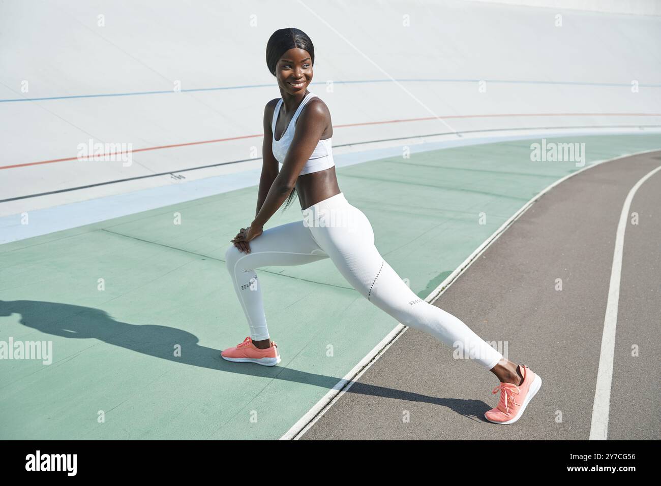 Full length of confident young African woman in sports clothing doing ...