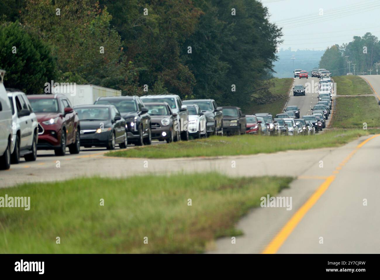 Residents wait in line for gas at Sam's Club in the aftermath of