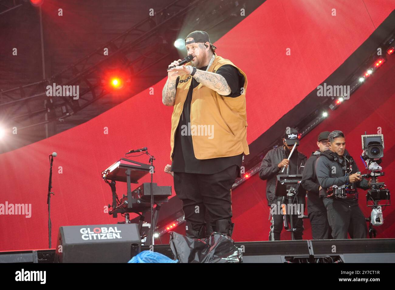 Jelly Roll performing energetically onstage at the Global Citizen