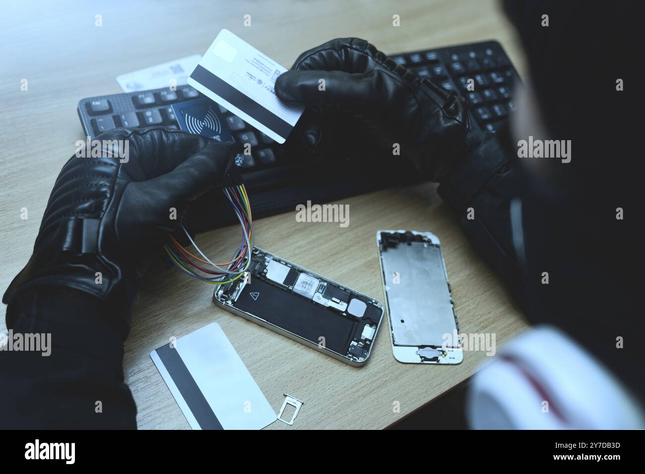 Hacking concept. Hacker trying to steal mobile payment information Stock Photo