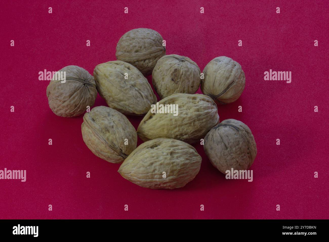 Walnuts on a red background Stock Photo