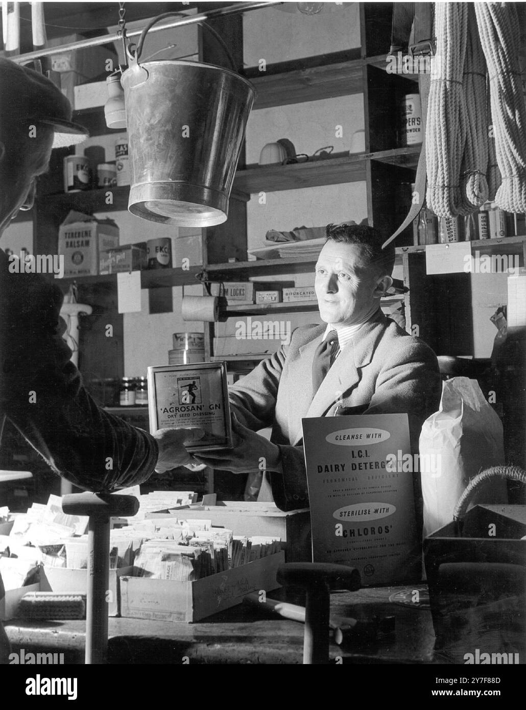 Welsh Farmers Co Op. When a branch of Hufena Meirion Ltd was opened at Llanuochllyn in the Vale of Penllyn, this farmer co-operative society was overwelmed with subscribers and quickly had to limit the amount of shares a farmer could buy. Under the direction of EB Owen who is manager and salesman a sale takes place 19th May 1951 Stock Photo