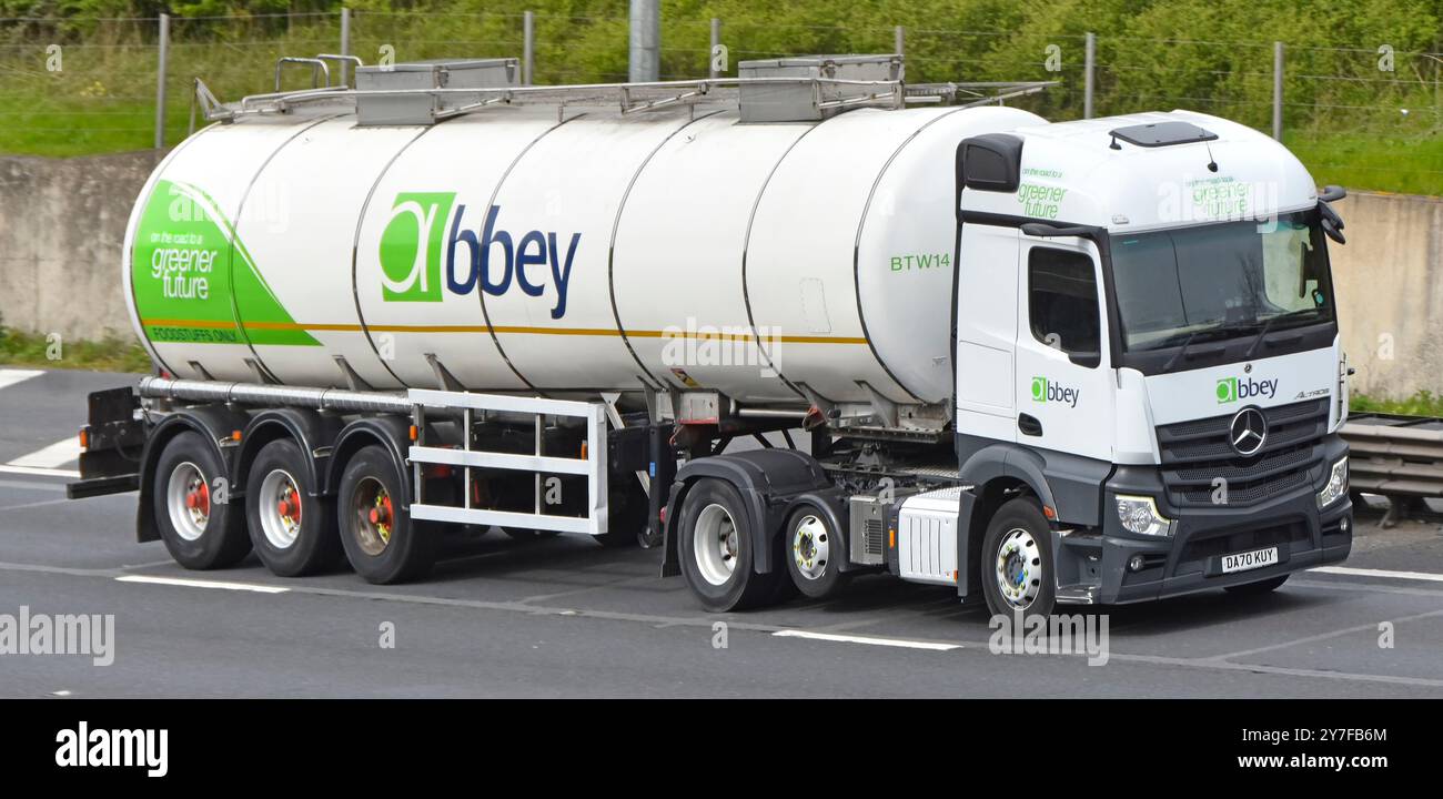 Abbey Logistics haulage brand bulk liquid or powder semi trailer tanker transport business Mercedes lorry truck driving M25 motorway Essex England UK Stock Photo