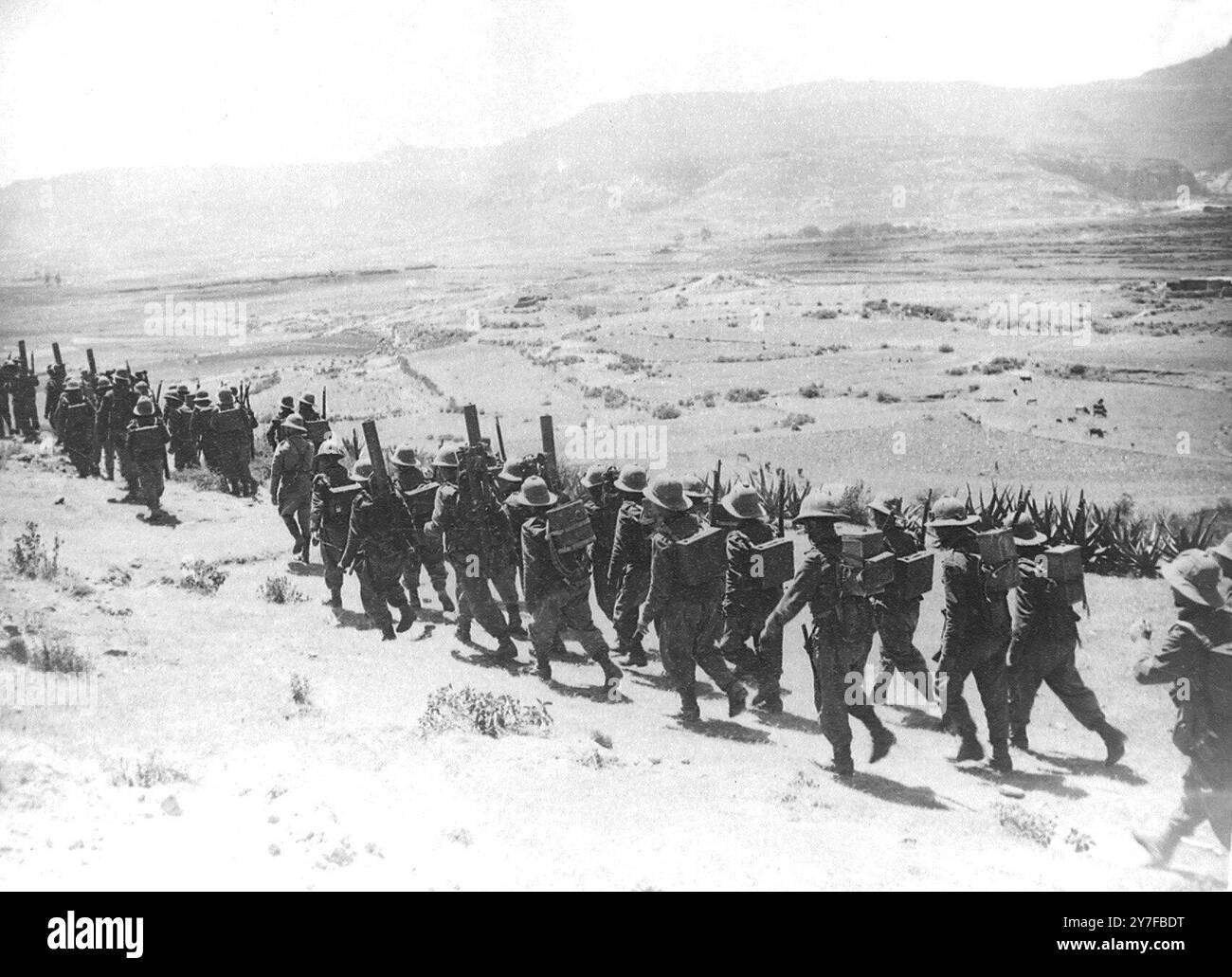 Italian Troops A column of Italian troops carrying hevy guns and equipment on their ...