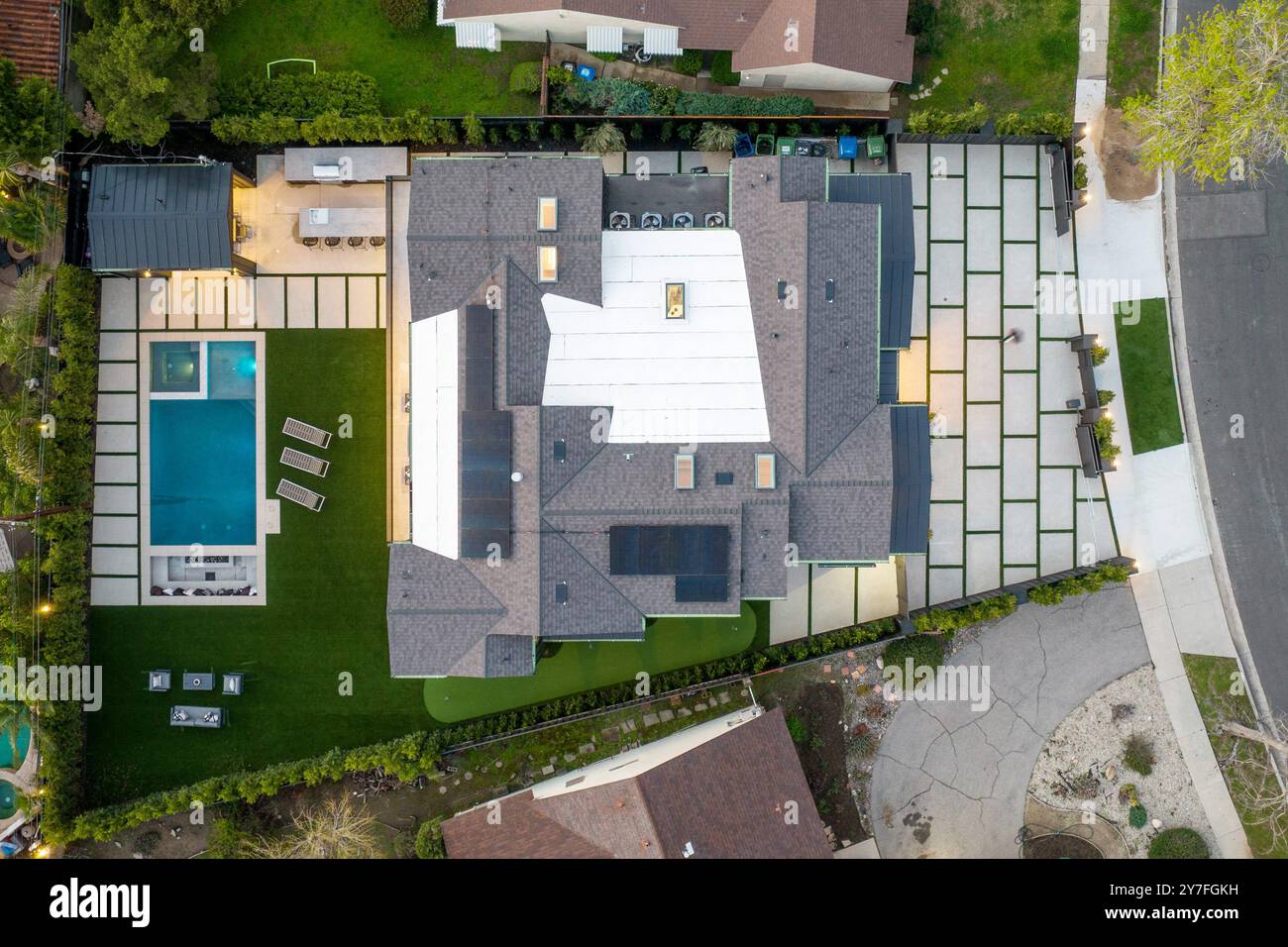 Aerial view of a modern house with a swimming pool and patio area in a ...