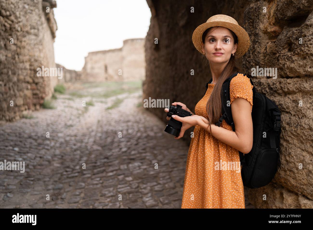 Woman exploring medieval castle with camera, photographing historic ...