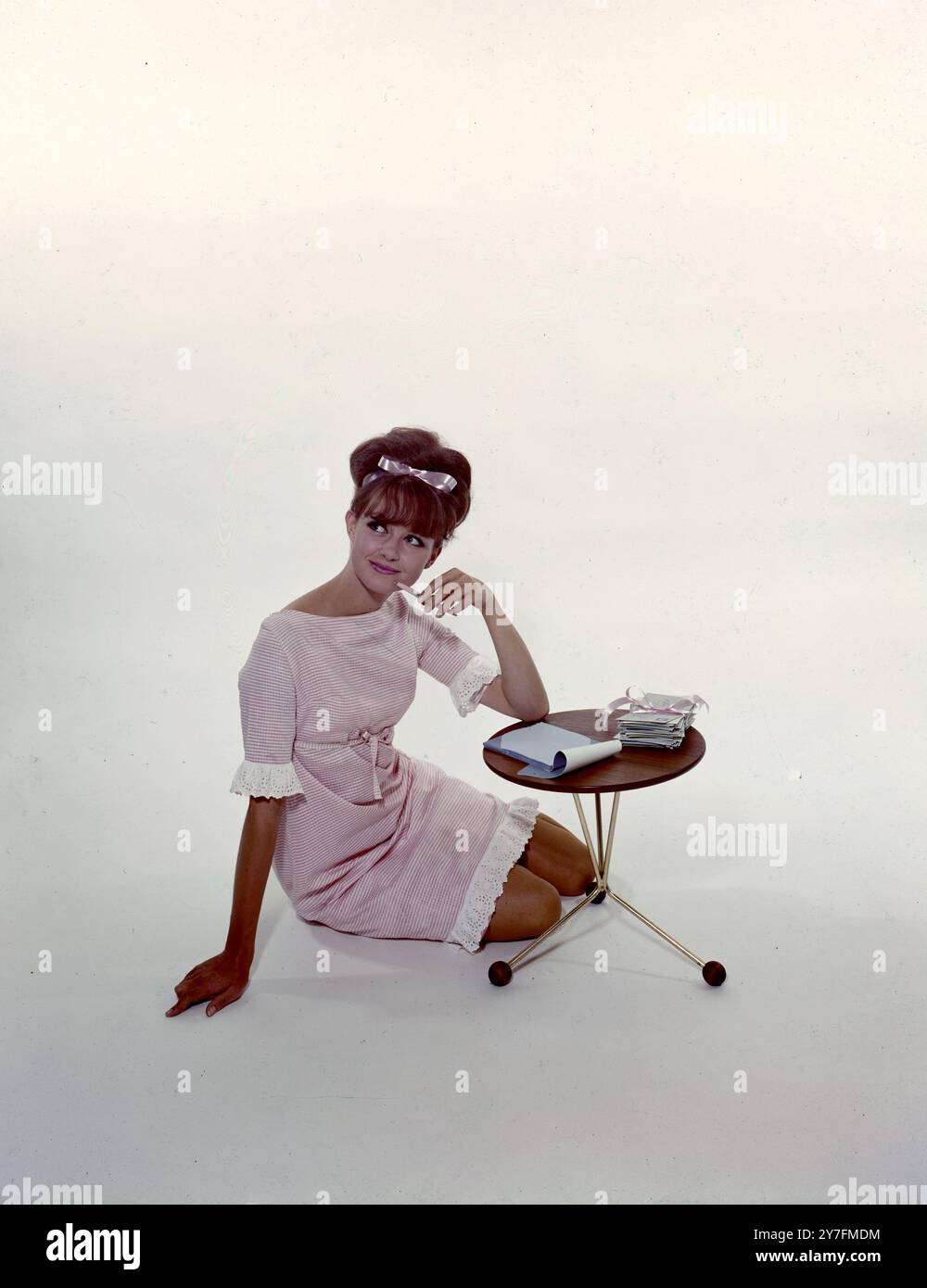 A young woman thinking about what to write in her letter 1960's Stock ...