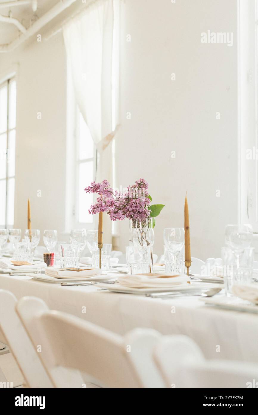 White wedding dinner reception with spring lilacs Stock Photo