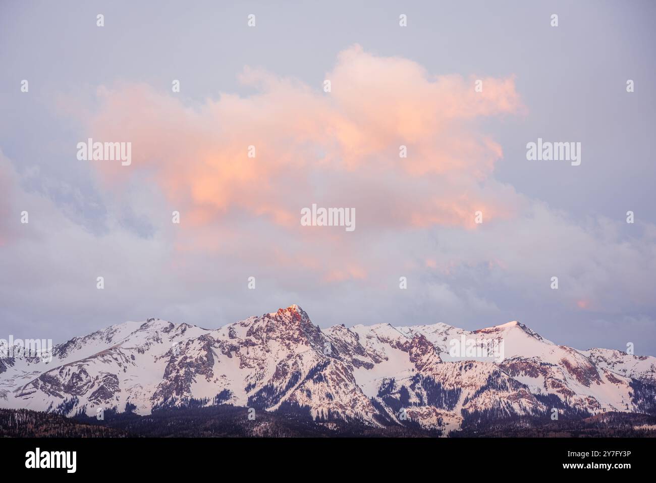 sunrise light on a snowy mountain peak with dramatic clouds Stock Photo ...