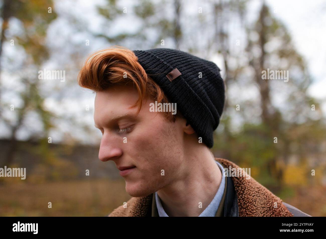 A young man with vibrant red hair wears a black beanie Stock Photo - Alamy