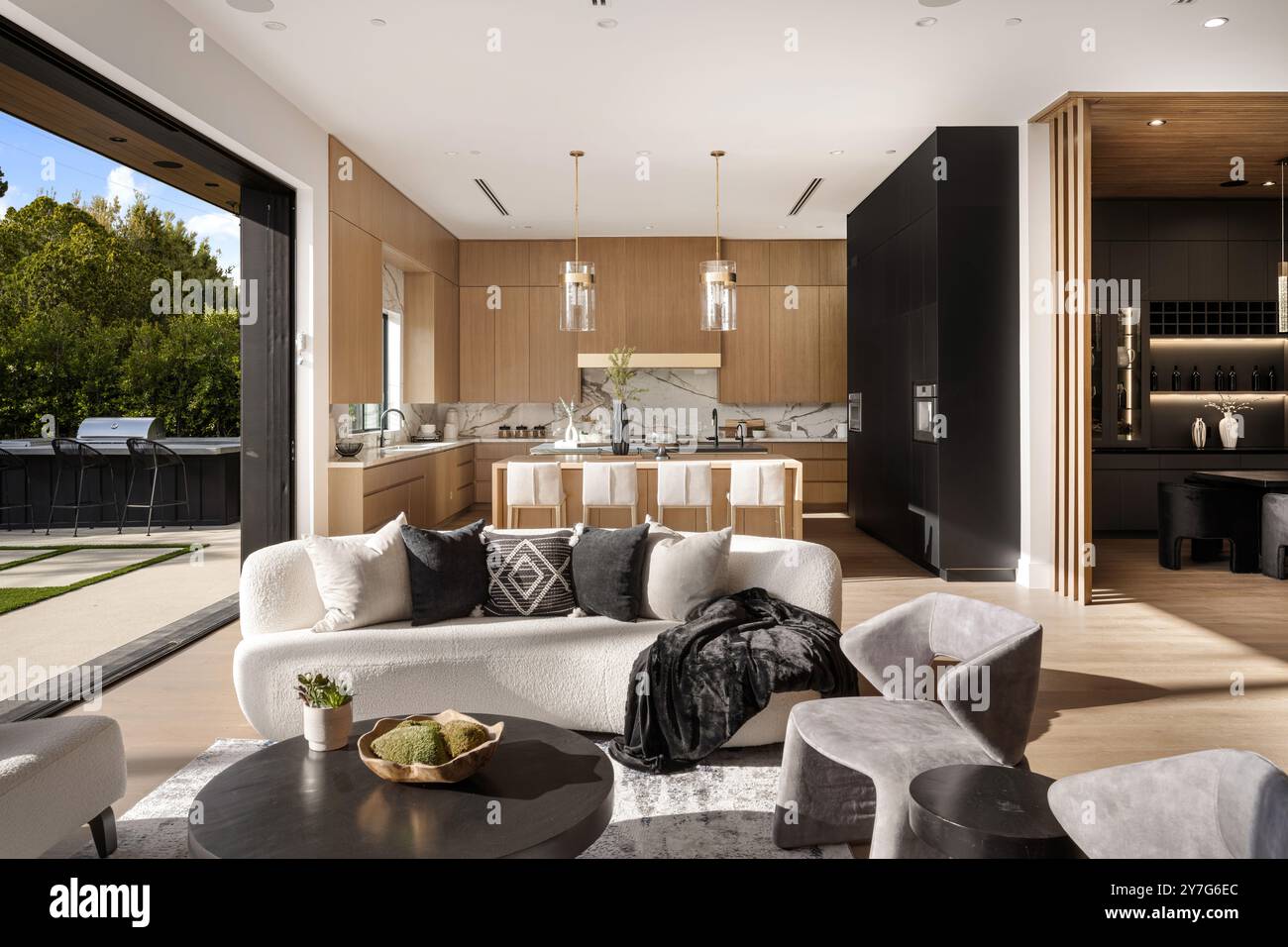 Modern open-concept living room and kitchen with natural light ...